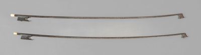 three pieces of metal are shown against a gray background