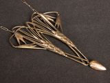 an image of a silver necklace with a bird design on it