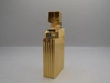a gold lighter that is sitting on a table