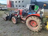 a tractor that is parked on the side of the road