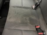 a dirty seat in the back of a car