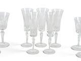 a lot of wine glasses that are lined up together