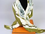 a green and white scarf on top of an orange box