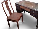 a wooden desk with a glass top and a chair