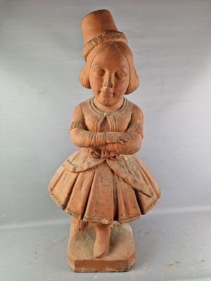 une petite statue représentant une fillette assise sur un bloc