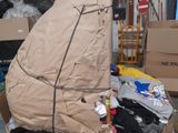 a cardboard boat sitting on top of a carton in a warehouse