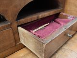 a wooden box with a pink velvet inside of it