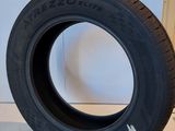 a close up of a tire on a white surface next to a wall