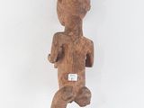 an old wooden statue of a man with a hat on his head