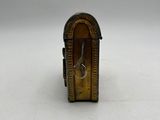 an image of a small gold clock on a white surface