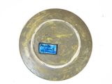 a plate with a blue label on it on a white surface