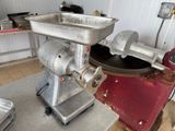a meat grinder sitting on a table in a kitchen
