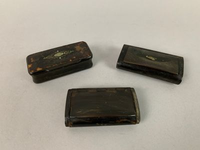 trois morceaux de bois posés sur une surface blanche