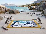 a lot of penguins that are standing on the beach