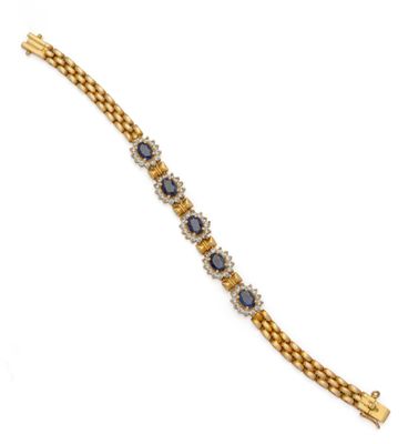 a gold bracelet with sapphires and diamonds