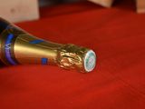 a bottle of champagne on a red table cloth