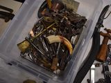 a plastic container filled with assorted tools on a table