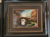 painting of a bridge over a river in a wooden frame