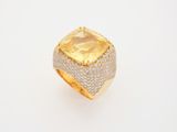 an 18k yellow gold ring set with a cushion cut citrine and pave diamonds