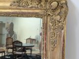 a mirror that is sitting on the wall next to a table