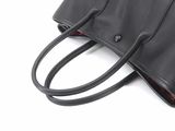 leather handbag on a white background with a black strap
