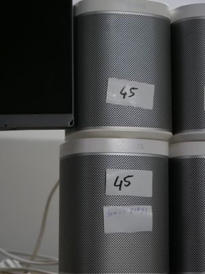 three speakers sitting on top of each other on a desk