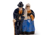 a figurine of a man and a woman sitting on a bench