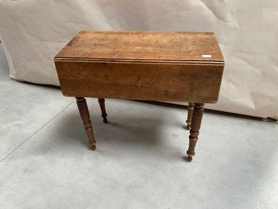 une vieille table en bois surmontée d'un petit tiroir
