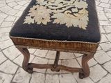 a black and gold ottoman sitting on a brick patio
