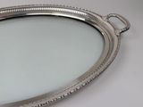 a silver tray with a mirror on it on a table