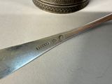 a spoon and a spoon rest on a table