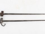 two old swords are laying next to each other on a white surface