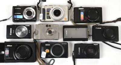 many different types of digital cameras laid out on the table