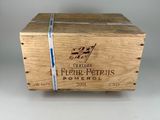 an old wooden box with a label on it sitting on a table