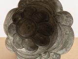 a metal object that looks like a flower on a table