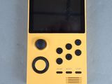 a close up of a yellow gameboy sitting on top of a table