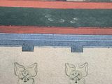 drawing of a black cat on a shelf with other cats on it