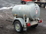 a trailer with a tank attached to it in a parking lot