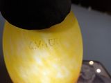 a yellow object with a black object on top of it