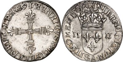 a silver coin with a cross and a crown on it