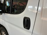 a white van parked in a garage with its door open