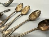 five spoons that are sitting next to each other on a table
