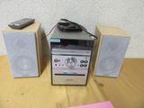 two speakers and a remote on a table