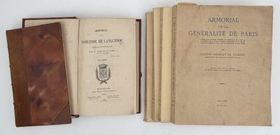 several old books sitting on top of each other on top of a table