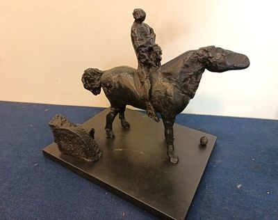 bronze statue of a man on a horse with a dog on the back