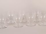 a lot of wine glasses and a decanter on the table