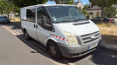 a white van that is parked on the side of the road