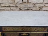 a marble top table with a black and gold design on it