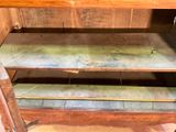 a wooden shelf that has a metal shelf on top of it
