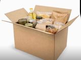 a cardboard box filled with food and condiments